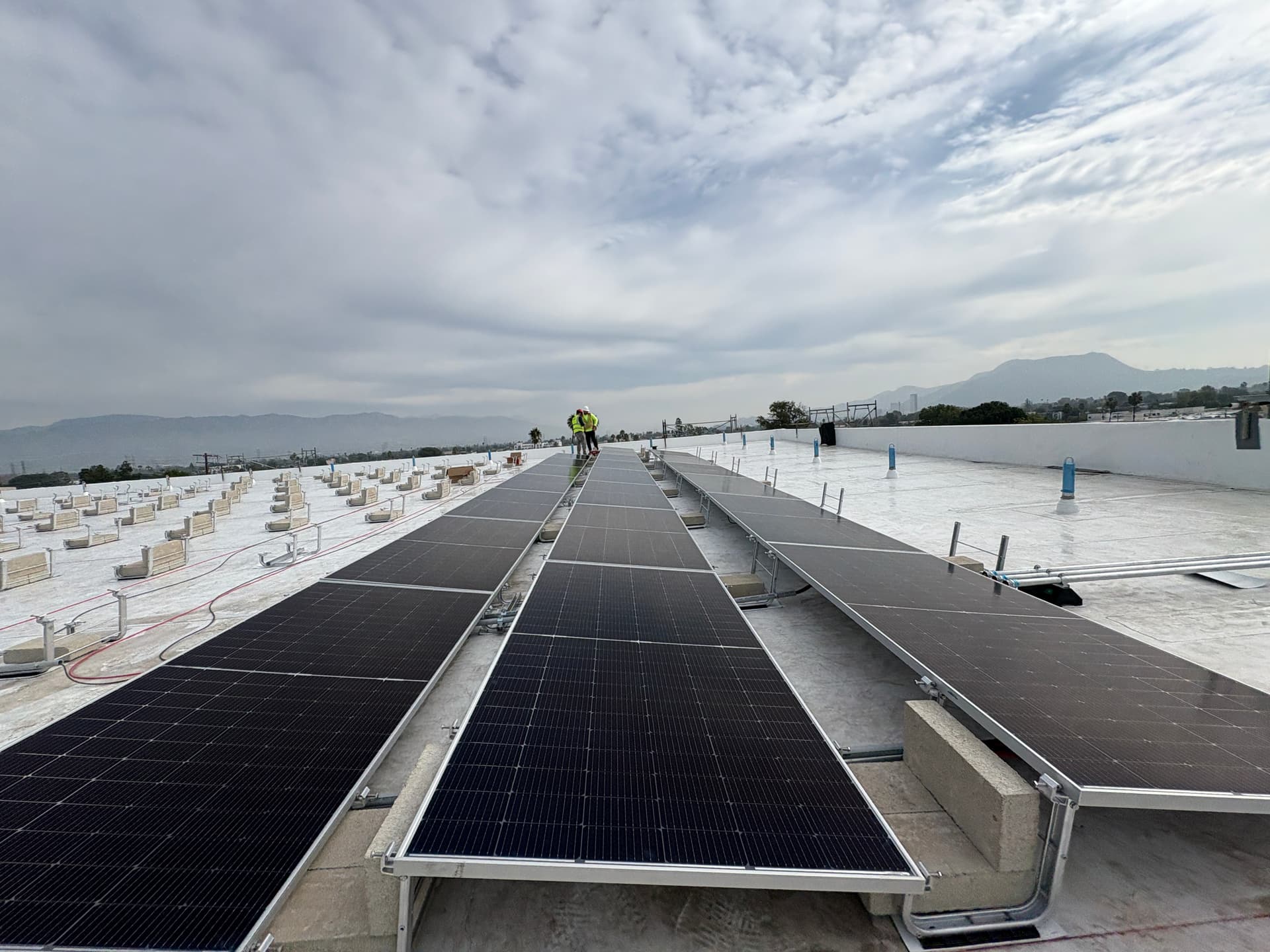 RCH Renewables C-10 licensed crew performing preventative maintenance on a commercial rooftop solar array
