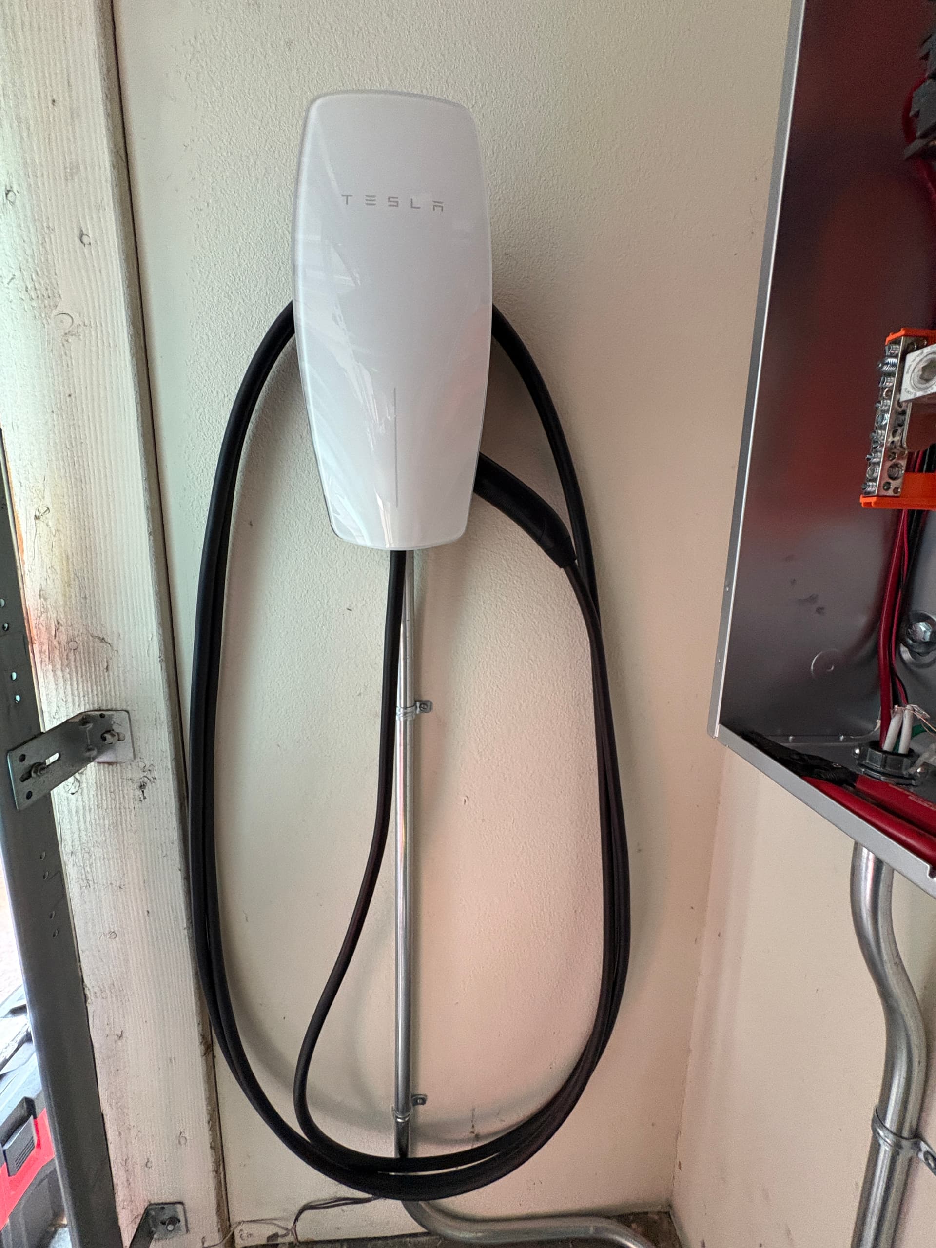 RCH Renewables electrician installing a dedicated EV charger circuit in a residential electrical panel.