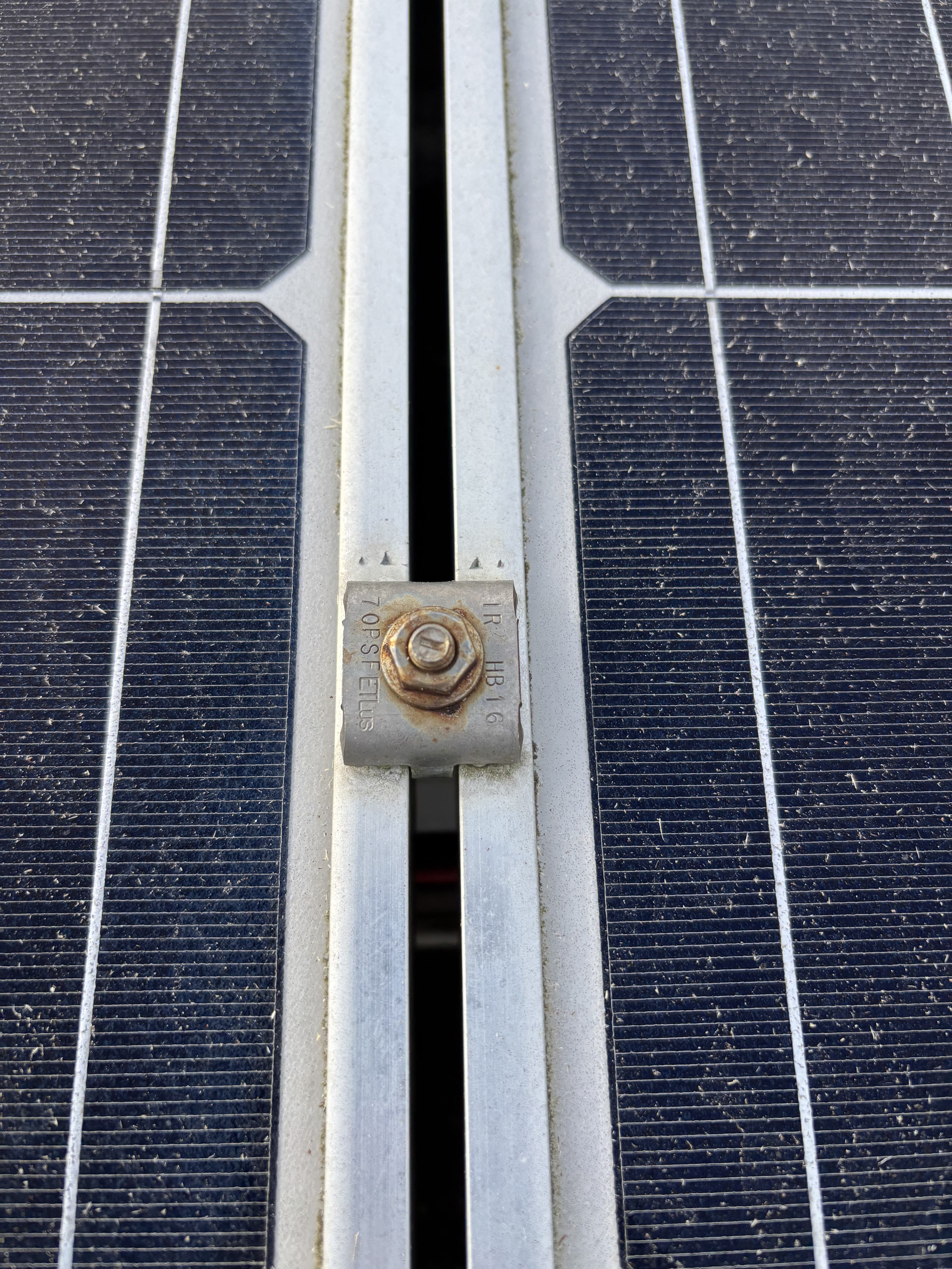 Corroded mid-clamp with a horizontal torque line indicating it was never torqued to spec