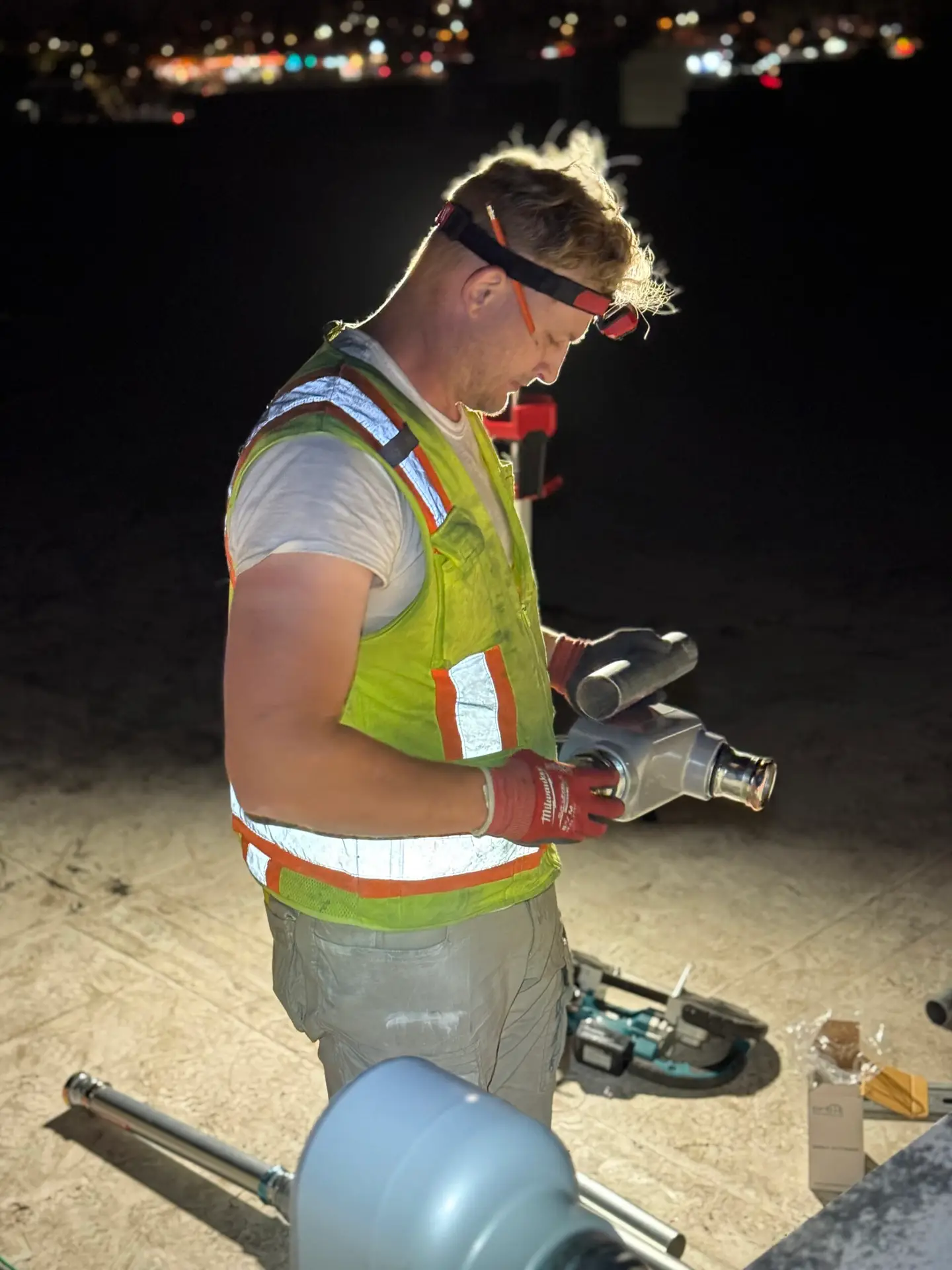 RCH Renewables technician working on a commercial rooftop at night
